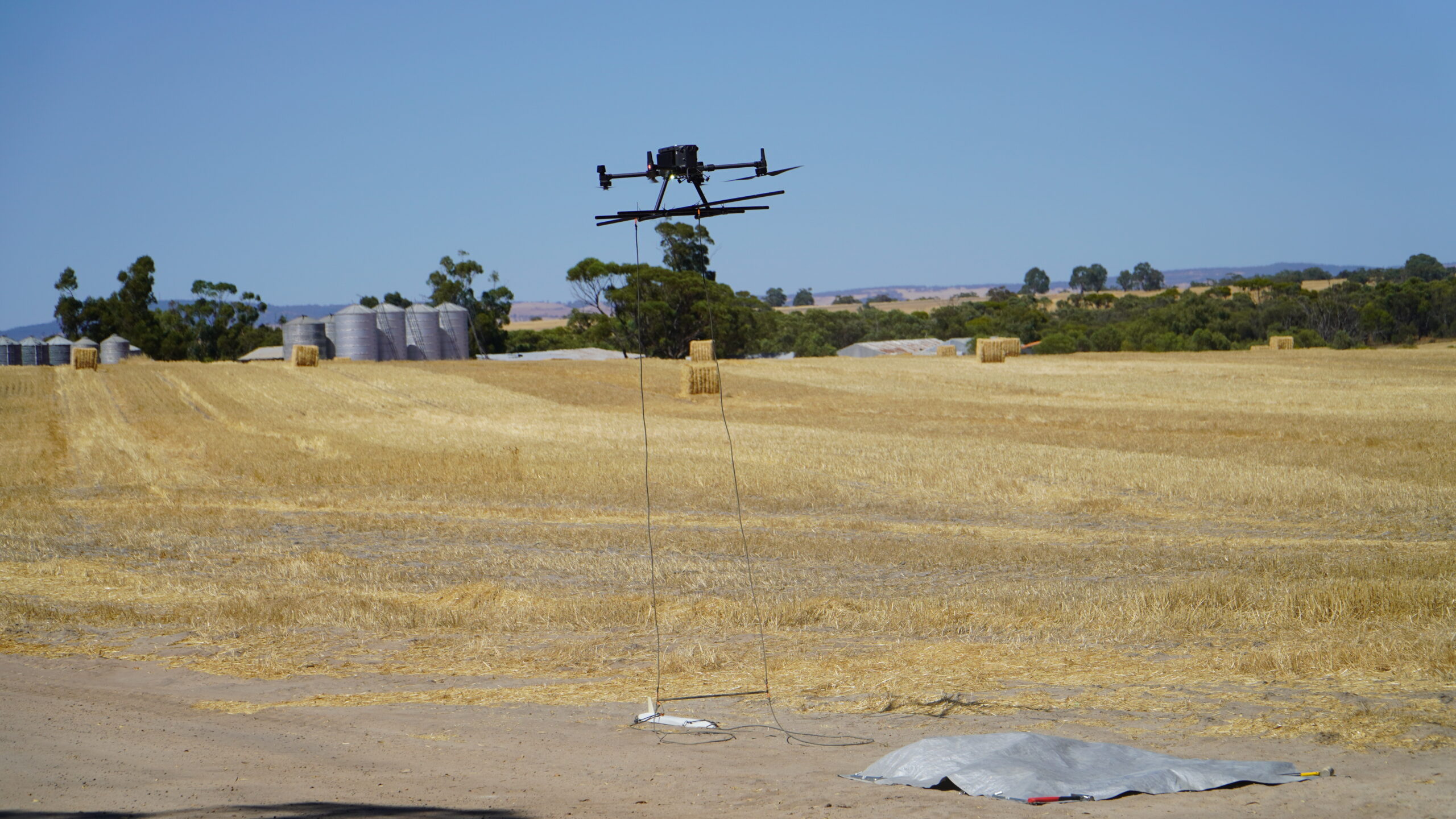 Close shot of Sensorem drone taking flight on farmland.