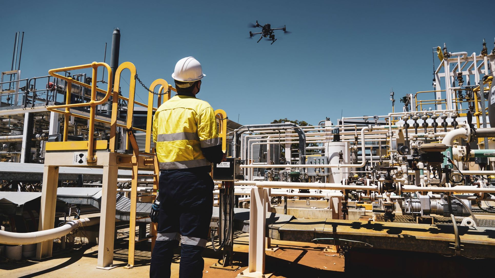 Sensorem staff member flies drone over a construction site.